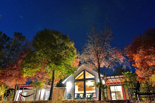 Home and deck overlooking mountains and night sky