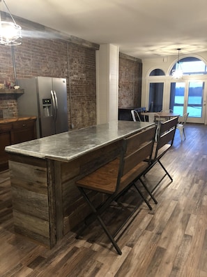 The kitchen and views of the river through the glassed in balcony.