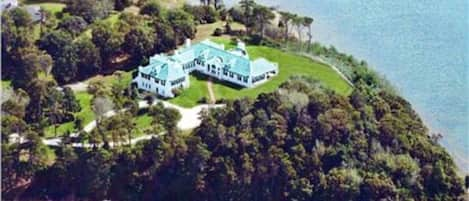 Aerial of the property. A point of land into Pleasant Bay. Water all around.