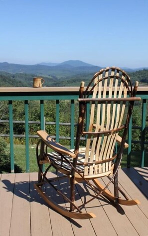 Relax with coffee and a rocking chair on the back deck.