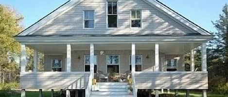 Cottage front with porch with ocean views to the west for beautiful sunsets
