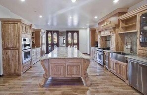 Piano bar, Full Kitchen with long granite counter in center and all around!
1 gas stove/ 2ovens, 6 electric stove cooker,1 microwave. Large pantry with cedar wood built in. French doors leading out to large balcony ,breakfast nook
