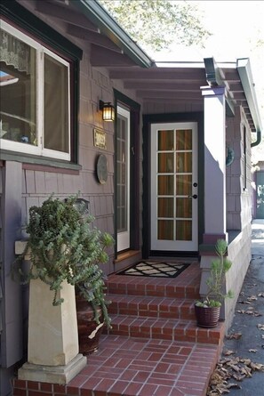 Second Entrance (left) and laundry room fully stocked (straight ahead).