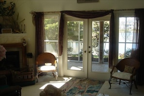 living area with view of screened porch with water view 