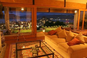 Living room has a wall of glass looking out onto the town and lake