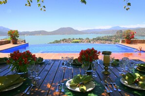 Poolside dining area under pergola