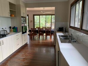 Kitchen opens onto dining room, with view of beach.