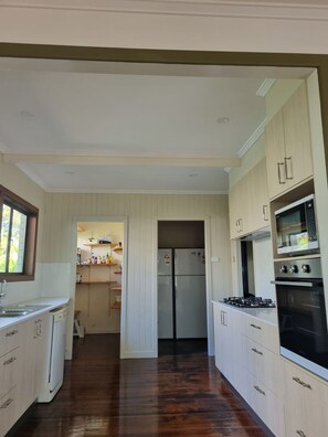 Large modern kitchen with walk-in pantry and two large fridges.