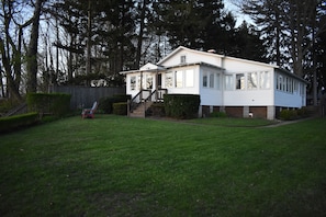 Front of cottage facing lake, entry steps to N. side back entry one step
