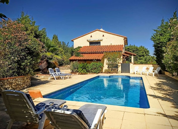 The view from the far end of the pool area, looking back towards the house
