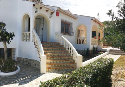 Villa from front, showing steps to front door & path towards terraced pool area