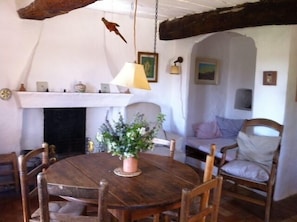 Living room fireplace and table, and extra bed in alcove