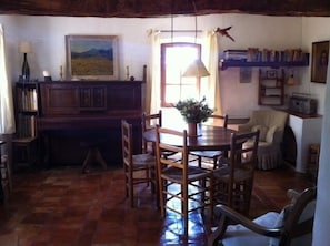 Living room with table for six and fireplace.. 