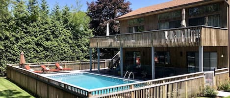 Large deck with  sectional in the shade for cooling off. Fenced in pool for kids