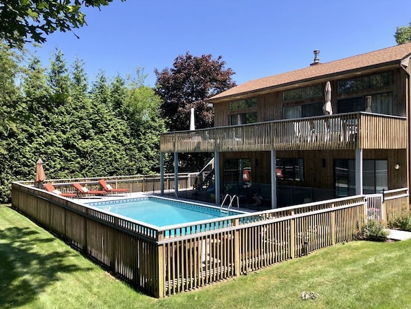 Large deck with  sectional in the shade for cooling off. Fenced in pool for kids