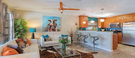 Open Concept Living-room with lots of natural light and a ceiling fan