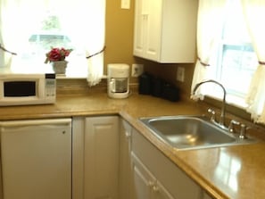 Galley kitchen with refrigerator, microwave, hot plate etc.