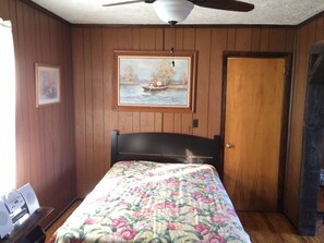 Main Floor Bedroom with Full Size Bed has folding door partition to Living Room