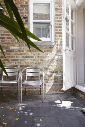 Private patio with table and chairs.