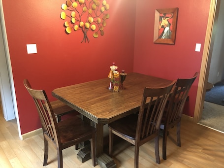 Kitchen table with bench seating on 2 sides and 4 chairs (3 pictured).