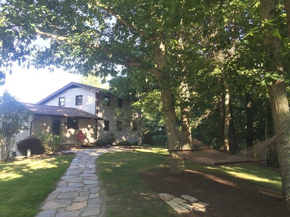 Flagstone walkway leading to the house. Don't miss the hammock on the way!