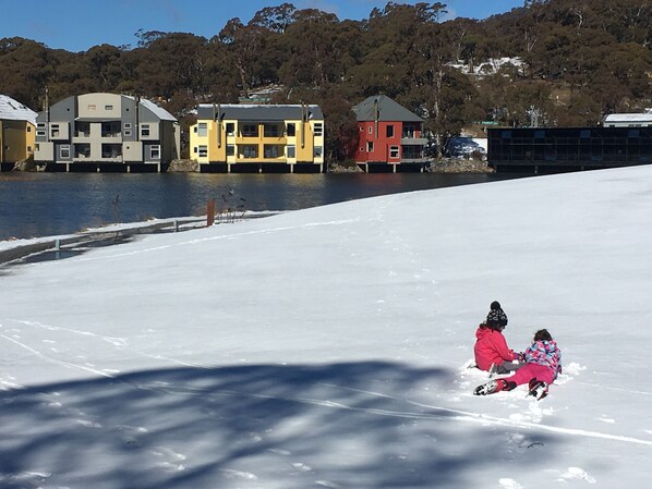 Our girls enjoying the snow on the resort grounds where our chalet is located.