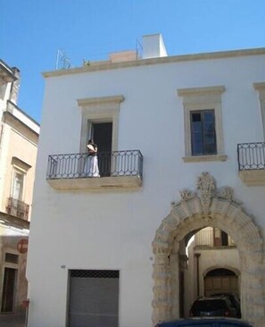 External view of the Palazzo with grand stone arch