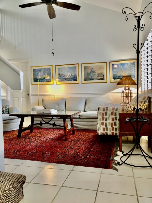 Downstairs living area with a  sturdy child's gate bottom of staircase.
