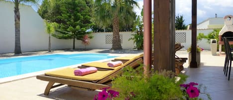 Landscaped gardens surround the pool and sunterrace