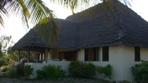 solid house embedded into mature tropical garden close to Indian ocean