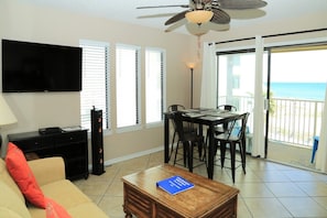 The sliding glass doors bring the outdoors in with sun-filled skies, pool & coastline views.