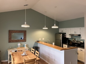 The kitchen and dining area (taken from coffee table in living room area)
