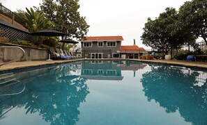 Fully fenced-in pool area with 6 chaise lounges, ping pong table and pool floats
