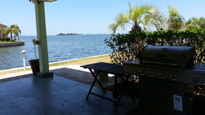 gazebo with gas grill and picnic table view of the water
