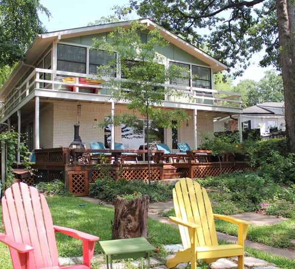 Lots of places to relax and gaze at the water in the wooded backyard