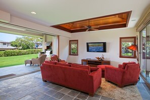 The spacious living room opens to the lanai and large yard