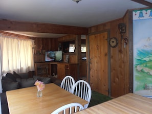 Looking from the kitchen into dining and living areas