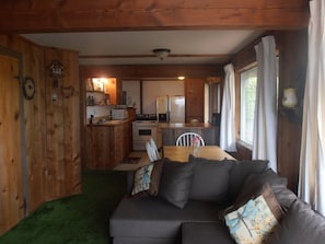 Looking back from TV area across the living area into the full kitchen