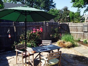 Small court yard with grill and garden.
