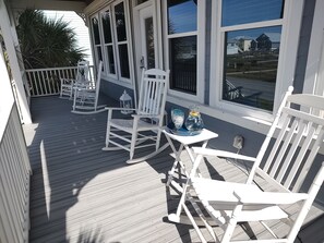 Front porch perfect for watching the waves, rocking  and sipping sweet tea