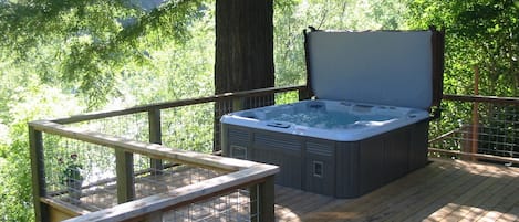 Relax in hot tub with view of river. 