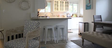 Fully stocked kitchen opens up to dining and living room.