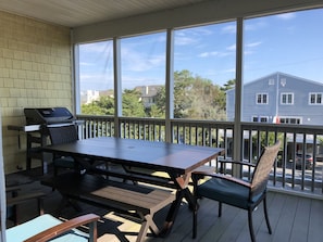 Main screened-in porch w/ grill and outdoor dining
