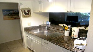 Newly remodeled kitchen with granite counters