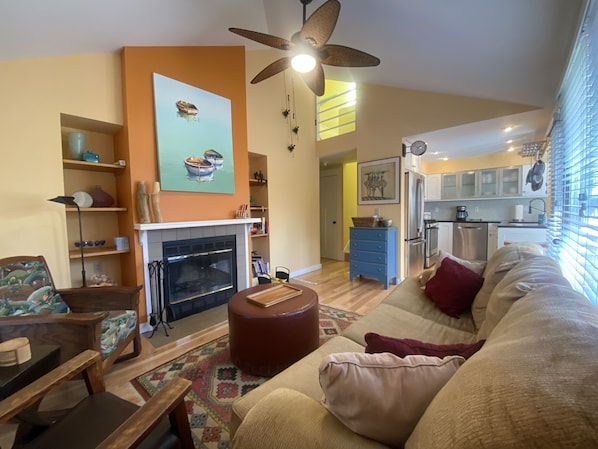 View of Living Room with Vaulted ceiling and adjacent kitchen.