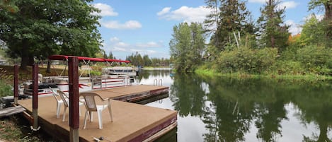 Our floating dock with a 21 foot pontoon boat; the lake is around two corners.