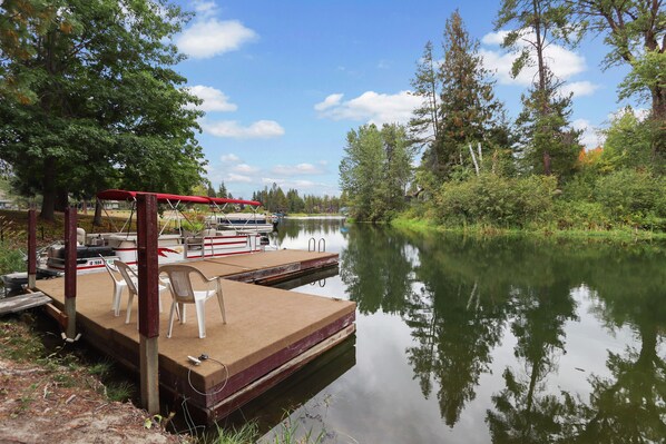 Our floating dock with a 21 foot pontoon boat; the lake is around two corners.