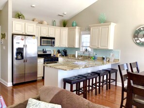 Large open kitchen.  Fully stocked with pots, pans, baking dishes, ect. 