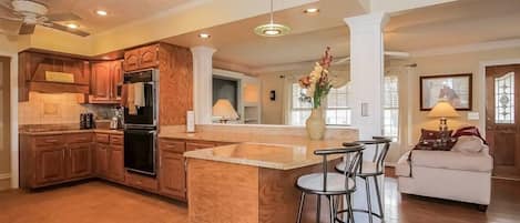 Spacious kitchen overlooks the gathering area