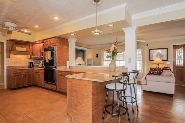 Spacious kitchen overlooks the gathering area